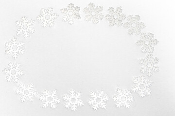 Frame of small white felt snowflakes, celebrating winter holidays
