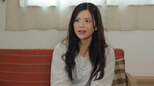 Asian woman chatting with her friend at living room. Fun, Happy, Cheerful. 25P