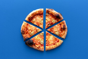 Homemade vegetarian pizza above view on a blue background