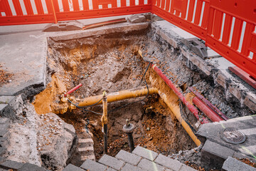 Excavation on a city street to replace plastic water pipes or laying cables. Repair and renovation...