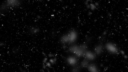 Falling snow flakes, Flying dust particles on a black background. Abstract winter background. Winter landscape with falling shining beautiful snow.