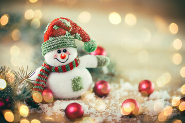 Christmas card. toy snowman on a festive background.