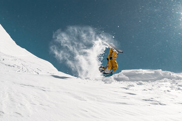 Naklejka na ściany i meble Snowboarder make jump and flip at ski resort. Extreme winter sports