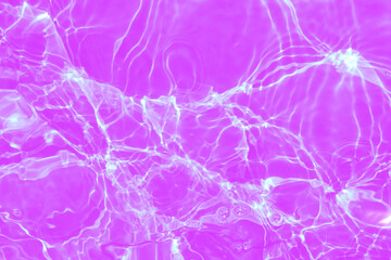 Obraz na płótnie Canvas Defocus blurred transparent purple colored clear calm water surface texture with splashes and bubbles. Trendy abstract nature background. Water waves in sunlight with copy space. Pink watercolor shine