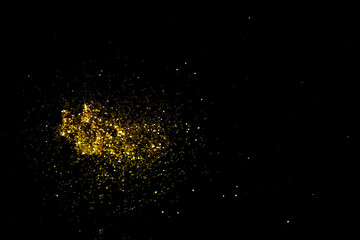 Fototapeta na wymiar Gold glitter powder sparkling on black background.texture christmas