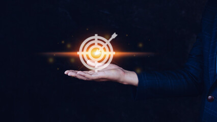 Targeting concept with businessman hand holding digital image of dartboard,Businessman holding...