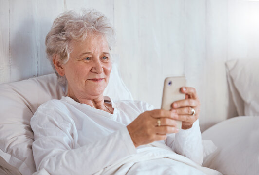 Bed, Phone And Relax Senior Patient Search Internet, Web Or Online For Subscription Movie, Show Or Entertainment. Healthcare, Elderly Care And Old Woman Streaming Video In Retirement Nursing Home