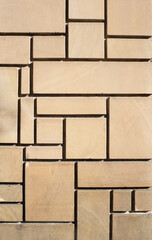 concrete wall with square and rectangular geometrical shapes imitating sandstone