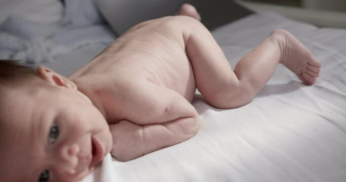 New born naked baby boy lies on the stomach