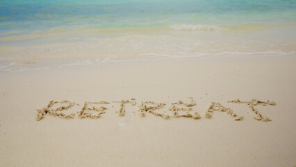Retreat Text Written On Sand Near The Idyllic Sea