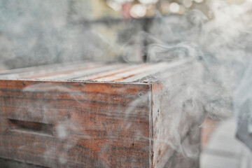 Smoke, wood box and bee farm or agriculture background for beekeeping and apiarist farming outdoor...