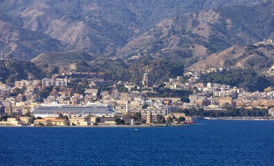 Fototapeta na wymiar Downtown City by the Sea with mountain background. Messina, Sicilia, Italy. Sunny Morning.
