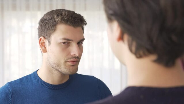 Bad breath. The man is bothered by bad breath.
The boyfriend chats with his friend, but his friend's mouth stinks and he is uncomfortable with it

