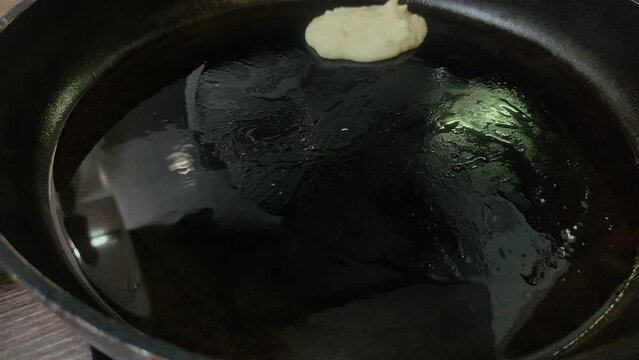 The cook is frying pancakes in a frying pan	
