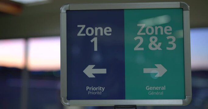 Airport boarding zone signs with priority and general zones