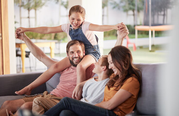 Happy family, smile and love, playing and sofa for quality bonding or relaxing together at home. Mother, father and children smiling for joy in playful fun and family time on the living room couch