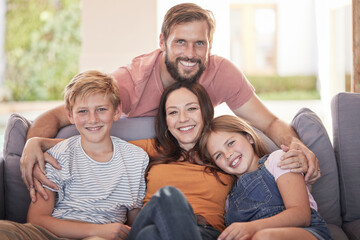 Family, hug and living room sofa with a mother, father and children smile with parent love and...