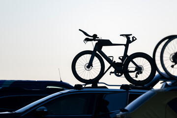 Silhouette image of bikes on car rooftop rack. Auckland.