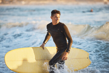 Surfing, water sports and surfer man at beach for fitness, wave and adventure during summer travel in Australia. Happy man in sea with surfboard for freedom, training and professional sport