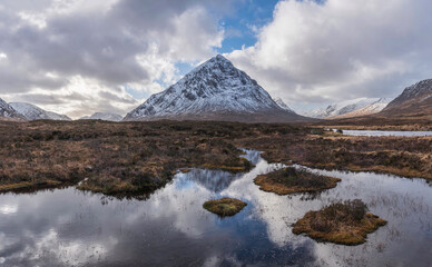 Majestic Winter landscape image of River Etive in foreground with iconic snowcapped Stob Dearg Buachaille Etive Mor mountain in the background © veneratio