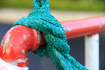 large green plastic rope Bonded to a large red iron rod.