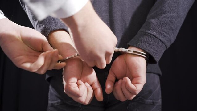 The criminal male was handcuffed by the police.
Police aggressively handcuffed the criminal.
