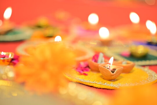 Indian Festival Diwali, Navratri, celebrations vertical picture by lighting colourful Diya Lamps Lights
