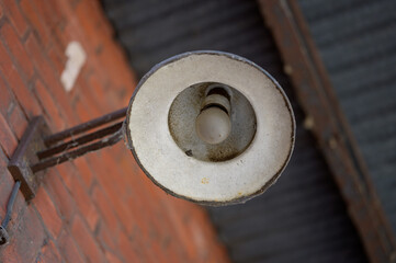 Lantern with a lightbulb on an old building