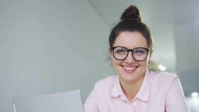 Positive businesswoman looking at camera and laughing, bragging with her success