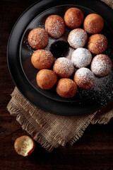Balls of freshly baked homemade cottage cheese doughnuts.
