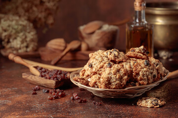 Oatmeal raisin cookies on a brown table.