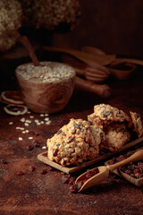 Oatmeal raisin cookies on a brown table.