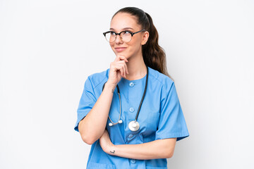 Young caucasian surgeon doctor woman isolated on white background looking to the side