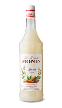 Glass bottle of Monin syrup, Almond Orgeat on a white background. Monin is a high-end French brand of syrups and toppings. isolated object 