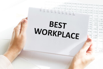 Closeup on businessman holding a card with text BEST WORKPLACE, business concept image with soft focus background and vintage tone