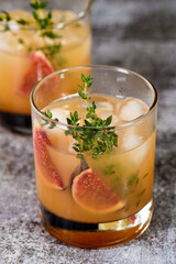 Bourbon Sour cocktail with fig spices, lemon juice and syrup. Easy to make but so delicious. Garnish with figs and thyme.