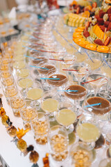 Glasses champagne on table served for buffet catering party outdoors, close up