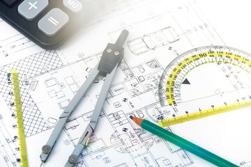 Designing a building or architecture with a ruler, pen, pencil, calculator and other equipment