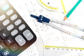 Designing a building or architecture with a ruler, pen, pencil, calculator and other equipment