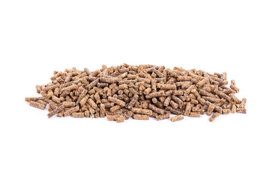Animal feed. Sunflower granulated feed  on white background, close-up. Animal cattle food pellets. Heap of animal feed pellets  on white background.