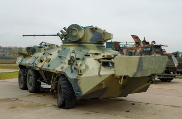 Fototapeta na wymiar Destroyed in the war Ukrainian armored personnel carrier.2022-11-04