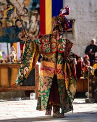 Tibetan Buddhist dancer in traditional demon spirit ghost clothing doing the ritual dance