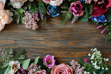 
beautiful floral layout composition with a variety of flowers and herbs on a wooden background....
