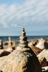 Fototapeta na wymiar Stone towers, stones stacked on top of each other along a beach in Latvia.