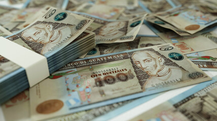 close up of Guatemalan quetzal notes spread on table. 3d rendering of money scattered on surface