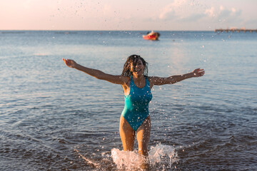 Sexy woman swimmer coming out of the water of the caribbean sea of the mayan riviera of Mexico,...