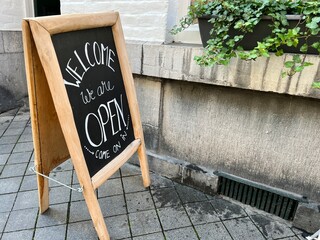 open sign board in front of a shop