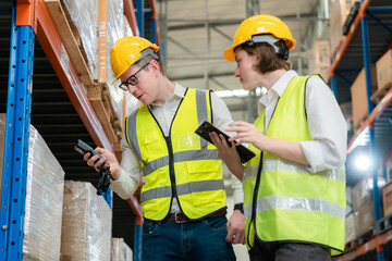 Managers, warehouse workers use machines to scan material numbers in large warehouses.