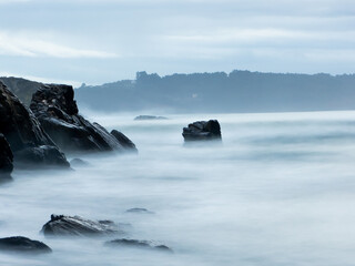 Rock sand and stone coast with silk water