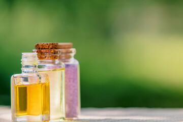 bottles of oils and massage and spa salts on a natural background